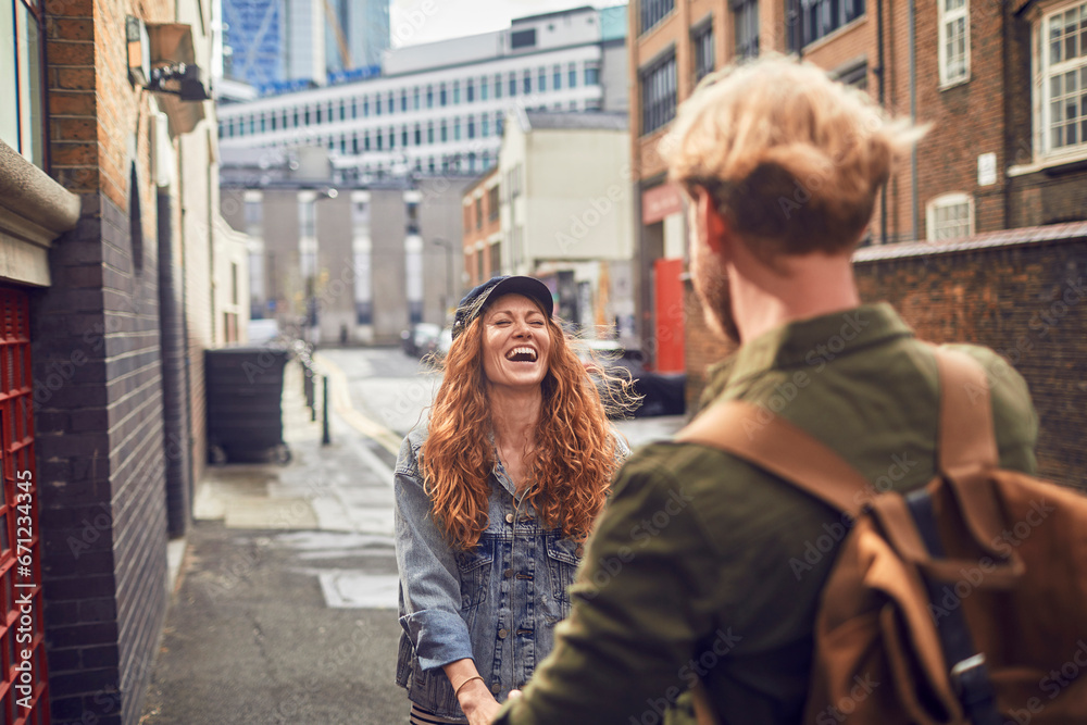 Joyful couple sharing a candid moment in the city streets