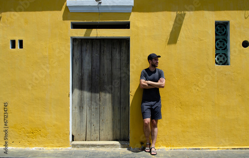 Traveler in front of real Hoi An yellow wall. Concept of tourism, travel and holidays. © Laia Balart