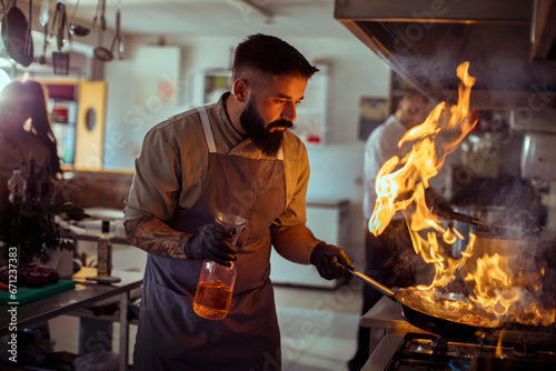 Chef Performing a Flambe in the Kitchen photo