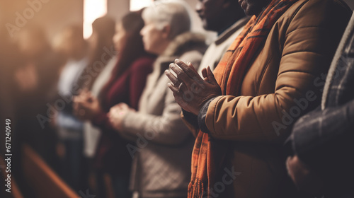 A family attending church together, holding hands in prayer, African American family, blurred background, with copy space photo