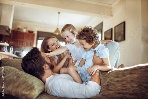 Fotografie Joyful family sharing a playful moment in their living room