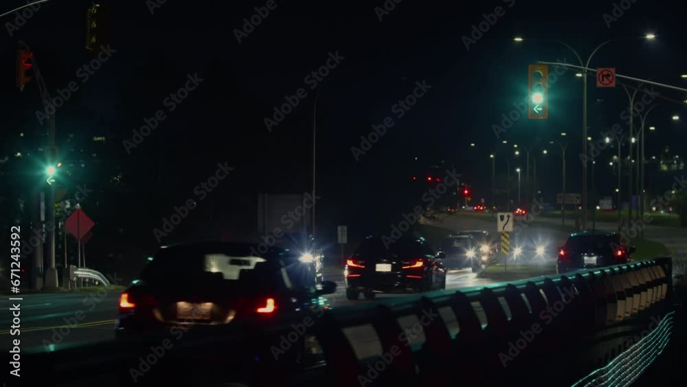 Night city traffic, cars move slowly, on a bridge with an intersection traffic Night city traffic, cars move slowly, on a bridge with an intersection traffic