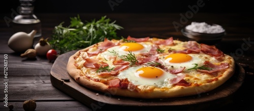 A mouthwatering pizza with savory ham flavorful onions and perfectly fried eggs situated in the center complemented by a backdrop of a dark wooden table in a subtly lit setting