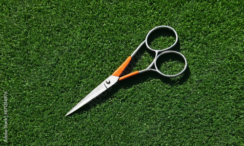 small scissors on a grass field