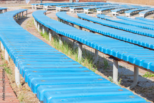 Wooden colored bench of spectators in the open air of a performance theater, close-up. AI generated.