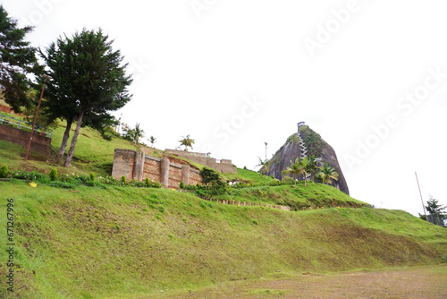 Guatapé, Antioquia, Colombia; October 25, 2023: A distant view of The Peñol Stone. Photo taken from the access road on foot to El Peñol monolith.  photo