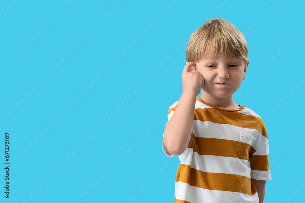 Thoughtful little boy on blue background Thoughtful little boy on blue background