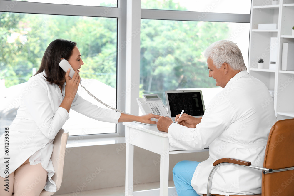 Fototapeta premium Doctors working at their workplaces in medical office