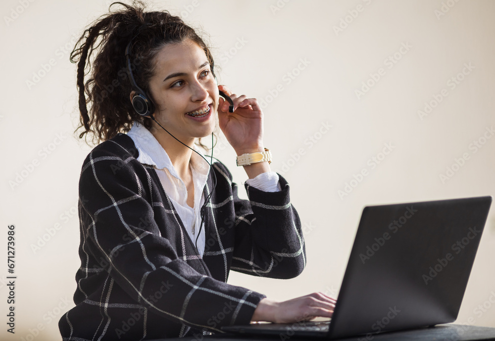 Girl with headphones and microphone working as client support Girl with headphones and microphone working as client support