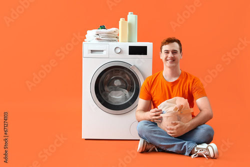 Young man with laundry sitt...