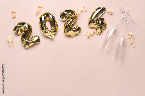 Figure 2024 made of balloons, ribbons and glasses for Christmas celebration on beige background