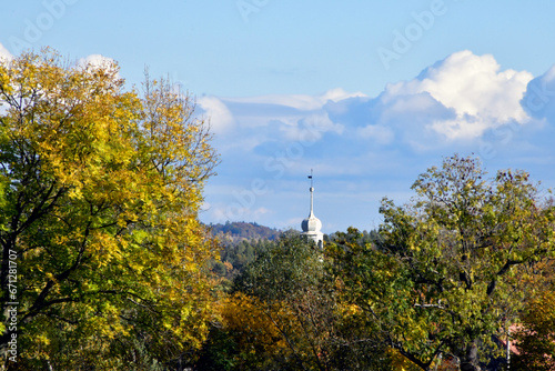 A distant view of the church tower in the countryside.