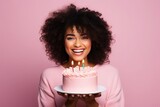 an afroamerican woman blowing out the candles on his birthday cake with a pink background