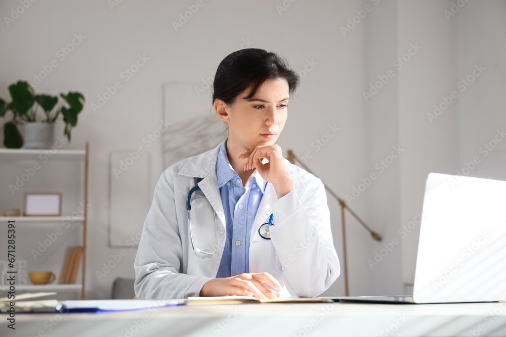 Female doctor video chatting with patient in office Female doctor video chatting with patient in office
