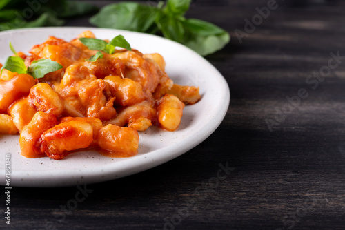 Gnocchi with tomato sauce, mozzarella cheese and basil. Italian traditional food.