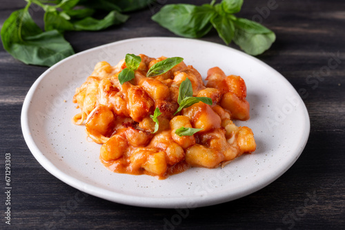 Gnocchi with tomato sauce, mozzarella cheese and basil. Italian traditional food.