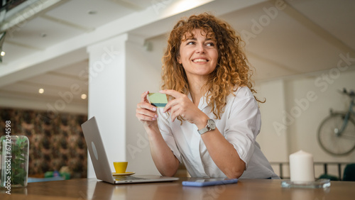 Woman happy caucasian female shopping online use credit card at cafe