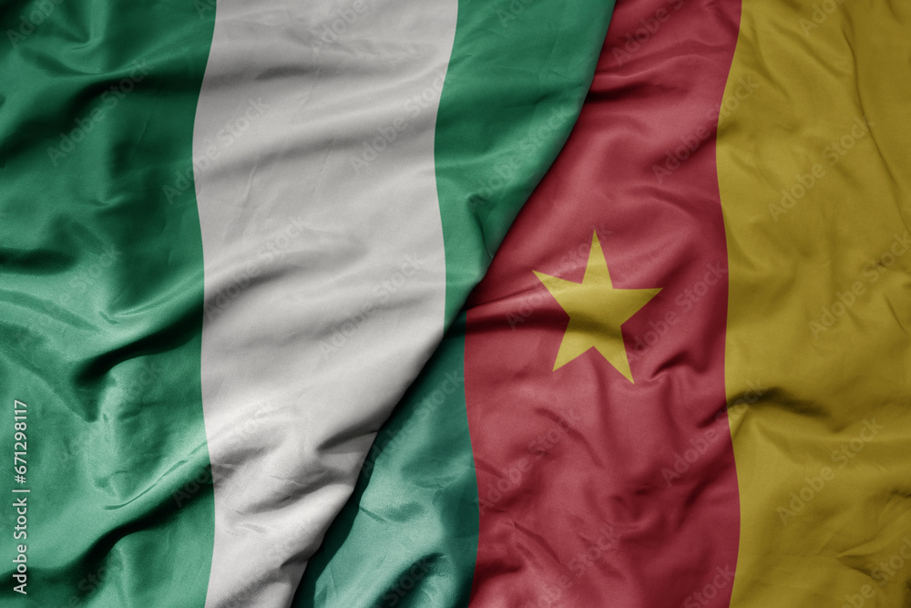Obraz premium big waving national colorful flag of nigeria and national flag of cameroon .