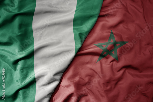 big waving national colorful flag of nigeria and national flag of morocco . photo