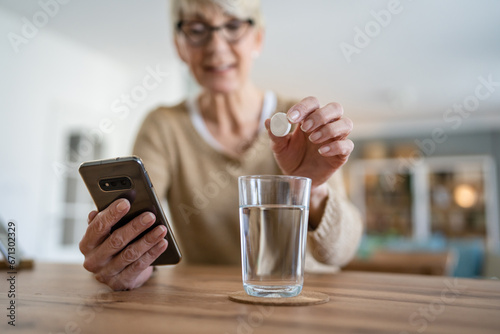 One senior caucasian woman take medicine drugs or supplement vitamin