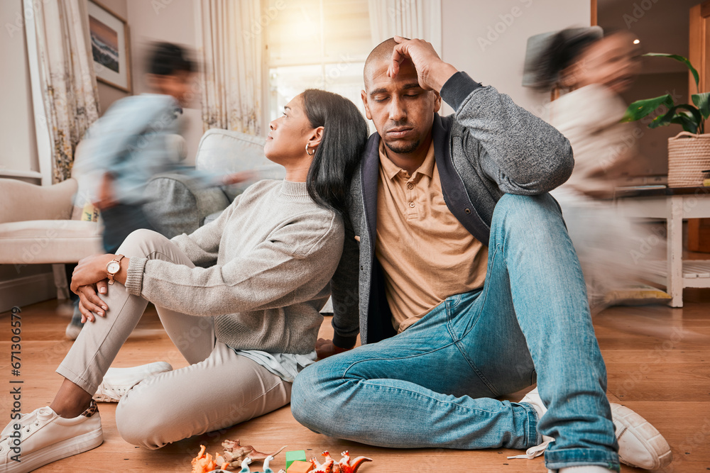 © C. Daniels/peopleimages.com - Family, adhd children and parents headache, stress and anxiety for autism management, energy fatigue or home noise. Tired mother and father on floor with chaos and hyper or fast, excited kids running