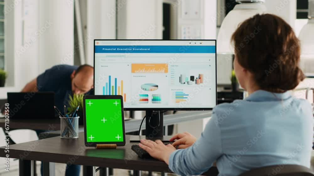 Business person using pc at workstation, having greenscreen display template on tablet in front of her. Manager planning startup operations and checking isolated mockup layout on device. Business person using pc at workstation, having greenscreen display template on tablet in front of her. Manager planning startup operations and checking isolated mockup layout on device.