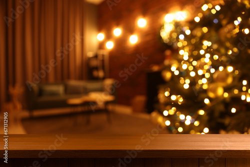 Empty wooden table in room decorated for Christmas, festive blurred interior. Space for design © New Africa