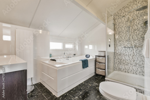 a modern bathroom with black and white mosaic tiles on the walls  along with a walk - in shower stall