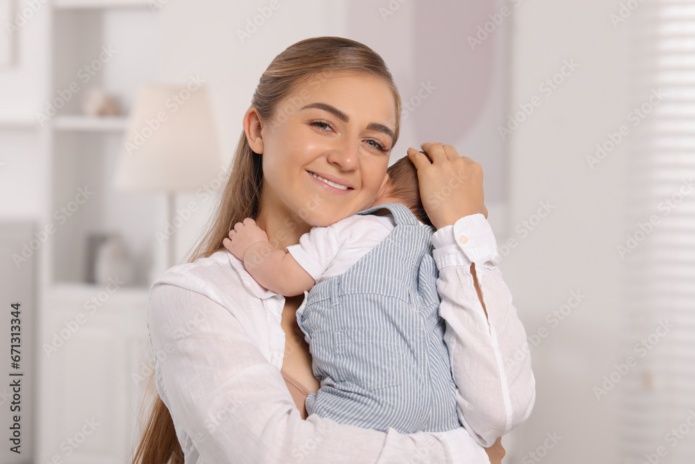 Mother holding her cute newborn baby at home Mother holding her cute newborn baby at home