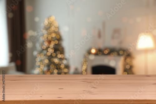 Wooden table in room decorated for Christmas. Space for design