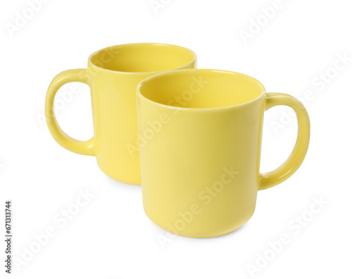 Two yellow ceramic mugs isolated on white