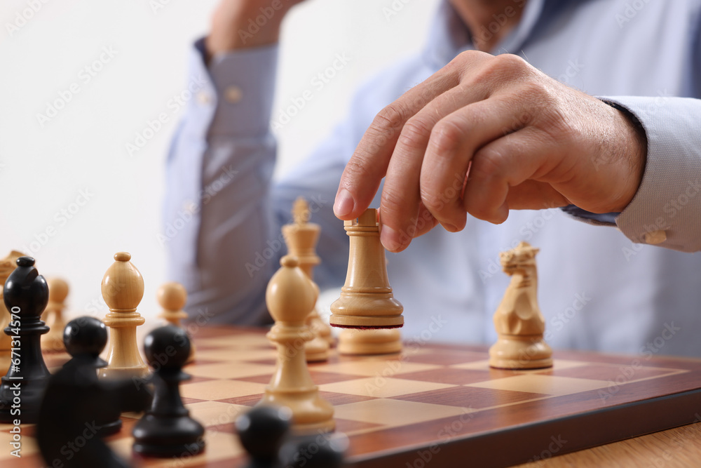 Man playing chess during tournament at chessboard, closeup Man playing chess during tournament at chessboard, closeup