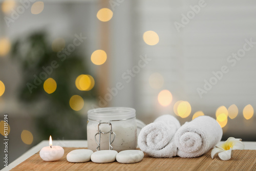Composition with spa stones and cosmetic product on table indoors  space for text
