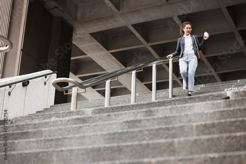 Walking, city and business woman on stairs with coffee for morning commute, journey and travel. Professional, worker and female person with drink for career, work and job in urban town by building © aLListar/peopleimages.com