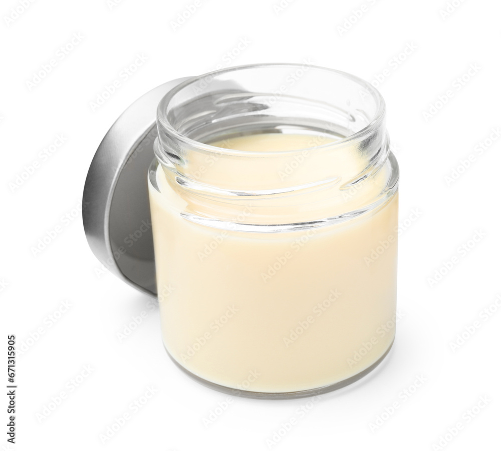 Open jar with condensed milk isolated on white Open jar with condensed milk isolated on white