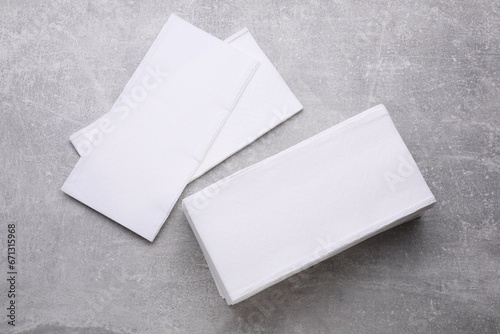 Clean tissue towels on light grey background, flat lay photo