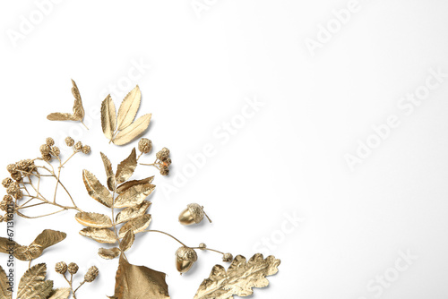 Beautiful golden leaves, berries and acorns on white background, flat lay with space for text. Autumn decor