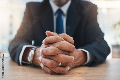Hands, authority and lawyer man waiting while sitting at a table in court during a case or trial closeup. Justice, law and legal with a male advocate in a courtroom for representation or legislation photo