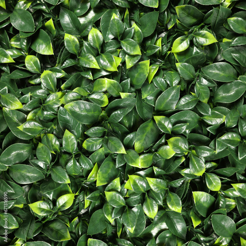 Lush bright green artificial plants as background