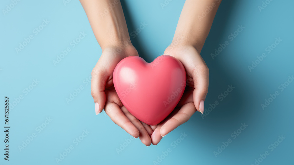 hands hold a pink heart on a minimal light blue background