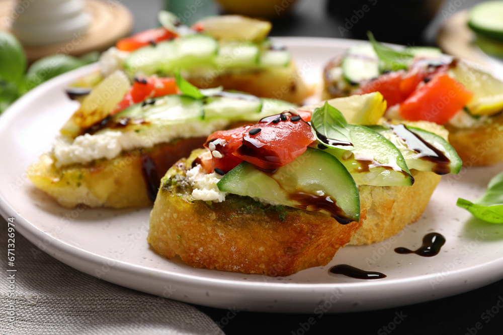 Delicious bruschettas with balsamic vinegar and toppings on table, closeup