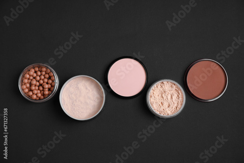 Different face powders on black background, flat lay