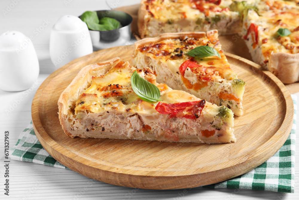 Tasty quiche with tomatoes, basil and cheese on white wooden table, closeup Tasty quiche with tomatoes, basil and cheese on white wooden table, closeup
