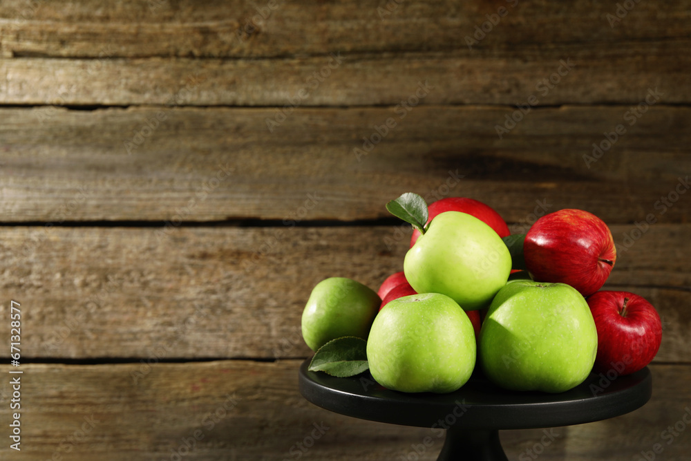 Stand with ripe red and green apples near wooden wall. Space for text Stand with ripe red and green apples near wooden wall. Space for text