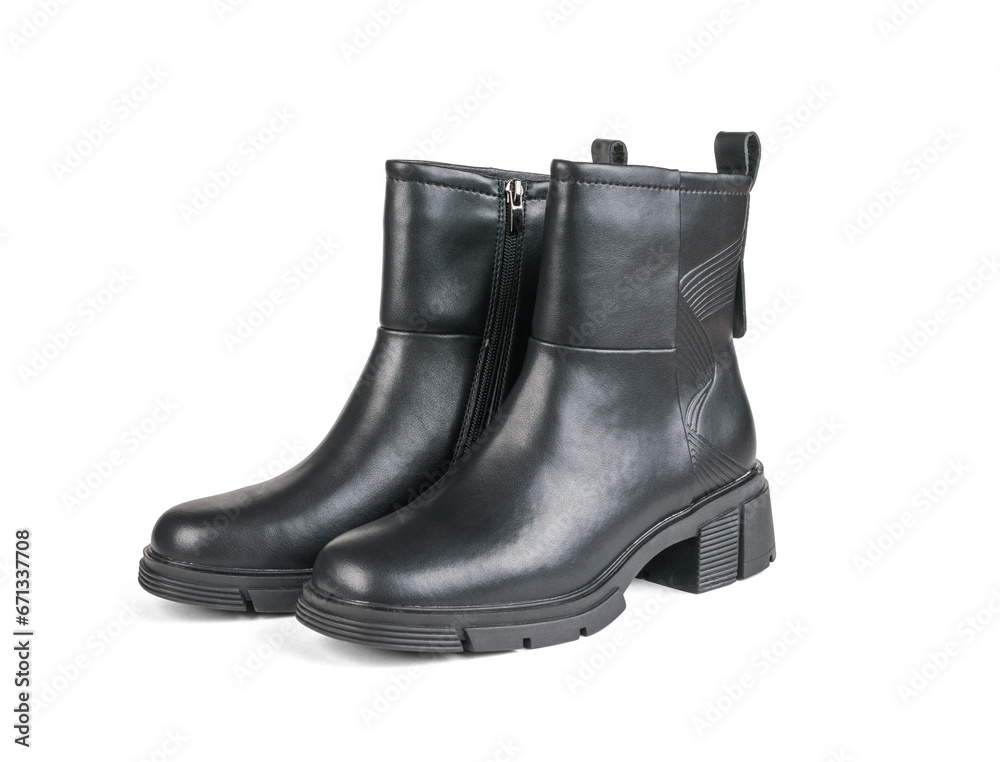 A pair of women's leather ankle boots with heels isolated on a white background. A pair of women's leather ankle boots with heels isolated on a white background.