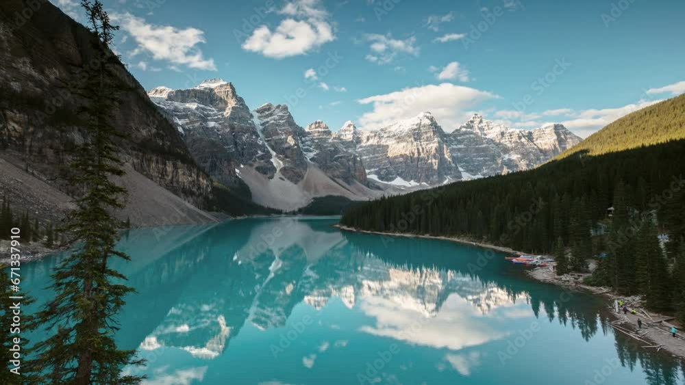 Moraine lake time lapse with mountain peaks reflected in the water, Banff national park, Canada