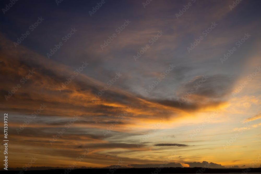 Beautiful sunset with wispy clouds painted in golden colors. Beautiful sunset with wispy clouds painted in golden colors.