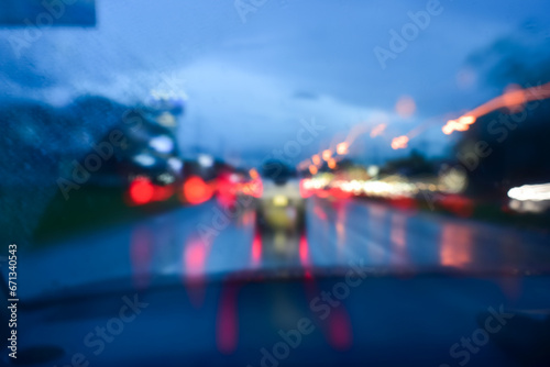 light of car on road in the night, blurred background in rainy day