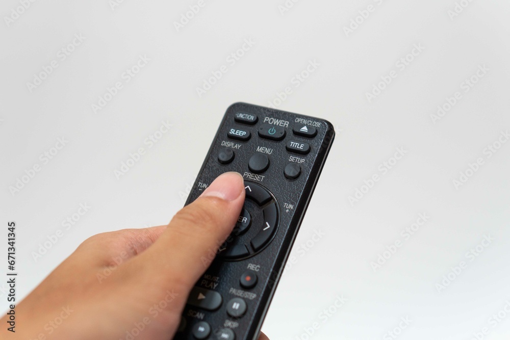 Hand holding television and audio remote control isolate on white background with clipping path Hand holding television and audio remote control isolate on white background with clipping path