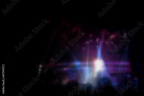Blurred of Christian Congregation Worship God together in Big Church hall in front of music stage and drak light effected.